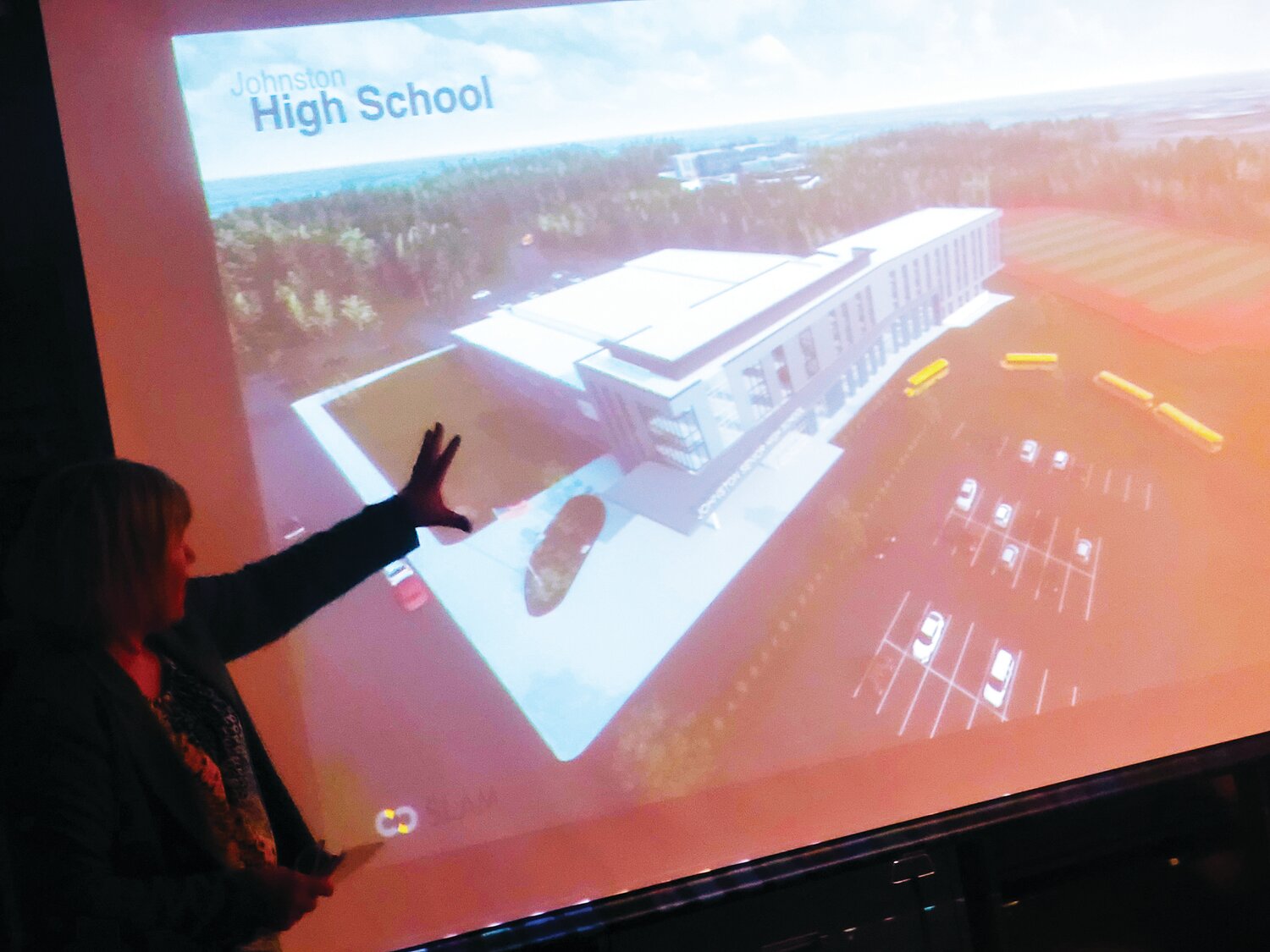 NEW JHS: Cathie Ellithorpe, Principal of the SLAM Collaborative, unveils the earliest rendering of a planned new Johnston High School.